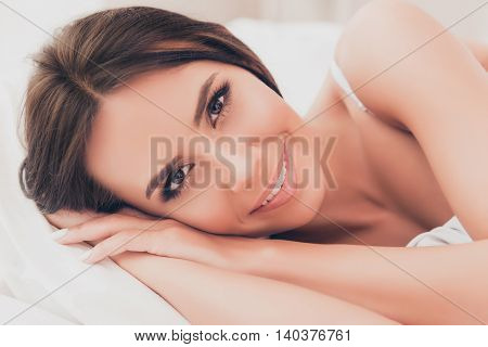 Portrait Of Beautiful Relaxed Young Woman Dreaming In Bed