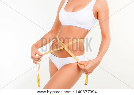 Close Up Of Thin Woman In Lingerie Doing Measuring Of Her  Waist