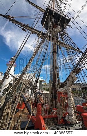 SYDNEY, AUSTRALIA - APRIL, 2016 : Carved head of sailor painted in fiery orange red and rigging ropes at foredeck of Tall Ship HMB Endeavour at Darling Harbour in Sydney, Australia on April 21, 2016
