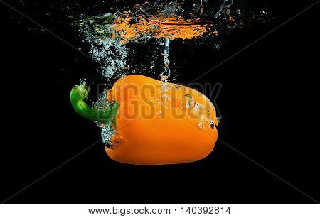 Bell pepper on black background with splashes