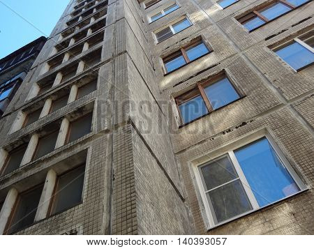Cheap apartments in old skyscraper. Walls are gray and depressive