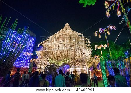 KOLKATA INDIA - OCTOBER 18 2015 : Night image of decorated Durga Puja pandal shot at colored light at Kolkata West Bengal India. Durga Puja is biggest religious festival of Hinduism.