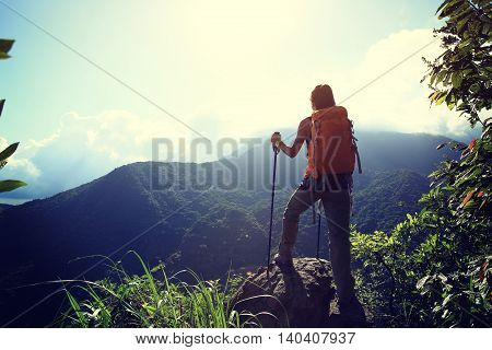 young woman backpacker enjoy the view on mountain peak