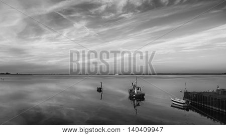 HIDDENSEE GERMANY - JUNE 9 2016: Boats at sunset on Hiddensee island Germany black and white