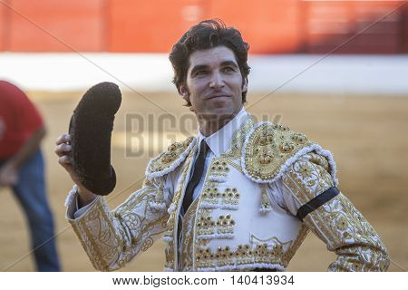 Sabiote SPAIN September 9 2011: The Spanish Bullfighter Cayetano Rivera to the turning of honour with an ear in his hand in the Bullring of Sabiote Spain