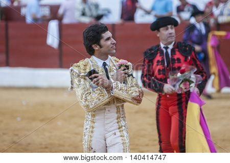 Sabiote SPAIN - Sptember 9 2011: The Spanish Bullfighter Cayetano Rivera greeting the public with its cap in the hand in gratitude to its bullfight in the Bullring of Sabiote Spain