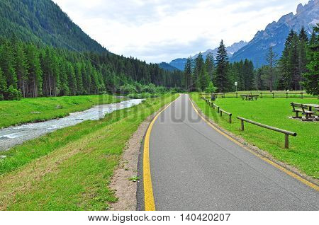 Asphalt path in Alps. norhern part of Italy
