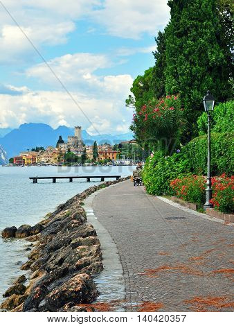 MALCESINE ITALY - JULY 27: Pedestrian promenade in Malcesine resort Italy on July 27 2014. Malcesine is a resort on northern part of Garda lake in Italy.