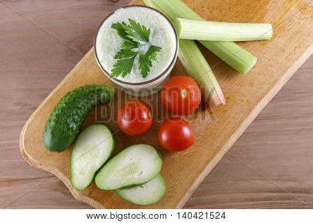Useful summer snack: vegetables and yogurt sauce with herbs. Against the background of a rustic wooden table