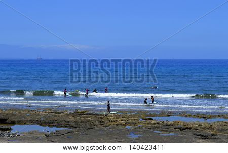 Playa De Las Americas beach Tenerife Canary Islands Spain Europe - June 12 2016 : Surfing on Playa De Las Americas beach