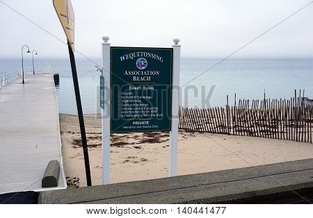 WEQUETONSING, MICHIGAN / UNITED STATES - DECEMBER 22, 2015: A sign provides the beach rules of the Wequetonsing Association Beach.