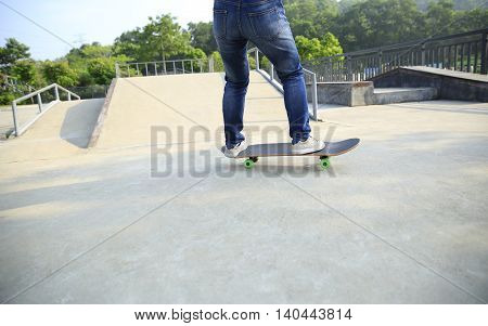 one young skateborder skateboarding at skatepark ramp