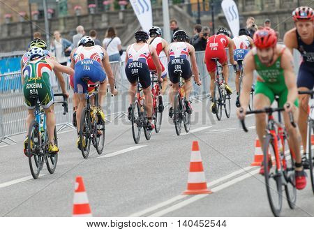 STOCKHOLM SWEDEN - JUL 02 2016: Rear view of a large group of male triathlete cyclists in the Men's ITU World Triathlon series event July 02 2016 in Stockholm Sweden