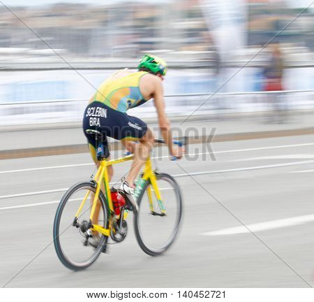 STOCKHOLM SWEDEN - JUL 02 2016: Side view of male triathlete cyclist Diogo Sclebin (BRA) slightly blureed in the Men's ITU World Triathlon series event July 02 2016 in Stockholm Sweden