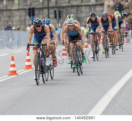 STOCKHOLM SWEDEN - JUL 02 2016: Group of colorful male triathlete cyclists Gregory Barnaby (ITA) and competitors in the Men's ITU World Triathlon series event July 02 2016 in Stockholm Sweden