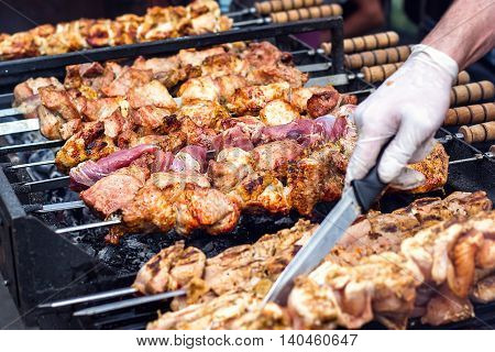 Marinated shashlik preparing on a barbecue grill over charcoal. Shashlik or Shish kebab popular in Eastern Europe. Shashlyk (skewered meat) was originally made of lamb. Roast Beef Kebabs On BBQ Grill.
