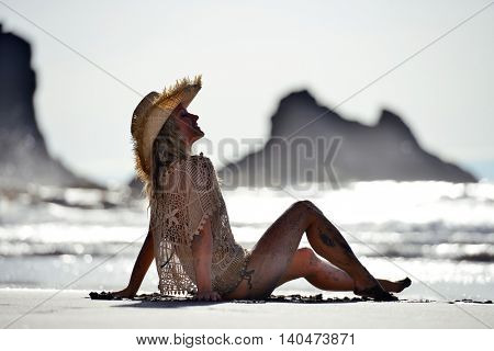 young woman relaxing on the beach in summer day