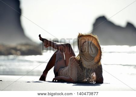young woman relaxing on the beach in summer day