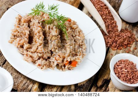Dish of red rice devzira dietary pilaf selective focus