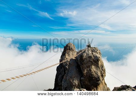hanging bridge in the mountains on the blue sky