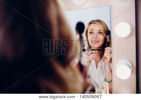 Positive smiling blond girl with make up
