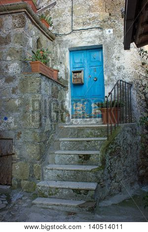 A bright blue woody door in a small Medieval town in Italy