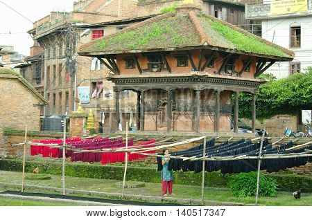 Bhaktapur,np - Circa August 2012 - Woman Deploying Colored Tissues, Circa August 2012 In Bhaktapur.