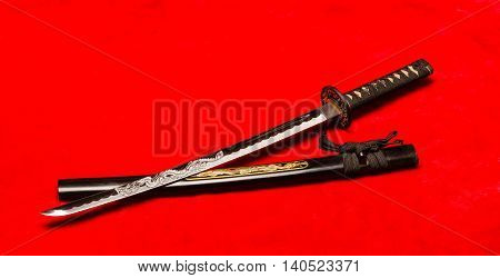 Japanese Samurai wakazashi short sword on plush red bacjground