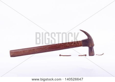 old rust Traditional curved claw hammer and nail tack used on white background tool isolated