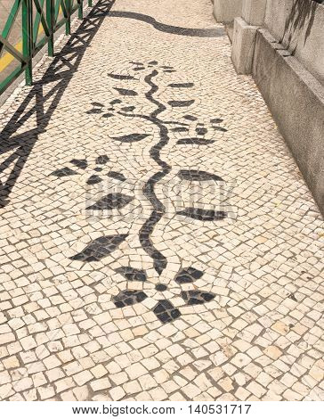 Mosaic in footpath plant pattern vertical black and white