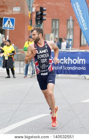 STOCKHOLM SWEDEN - JUL 02 2016: Running triathlete Adam Bowden (GBR) looking back in the old town of Stockholm in the Men's ITU World Triathlon series event July 02 2016 in Stockholm Sweden