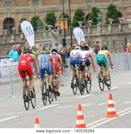 STOCKHOLM SWEDEN - JUL 02 2016: Rear view of a group of male triathlete cyclists in the Men's ITU World Triathlon series event July 02 2016 in Stockholm Sweden