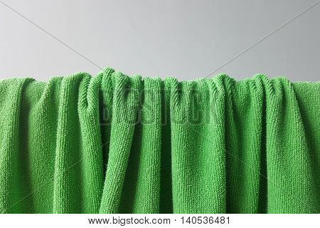 green towel folded and hanged with shade