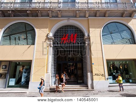 ATHENS-AUGUST 22: H&M shop on Emrou street on August 222014 Athens Greece. H & M is a Swedish retail-clothing company known for its fast-fashion clothing for men women and children.
