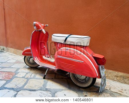CORFU-AUGUST 22: Vintage Vespa scooter parked on Kerkyra street on August 22 2014 on Corfu island. Greece. Vespa is an Italian brand of scooter manufactured by Piaggio.