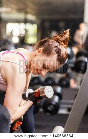 Young Woman Doing Exercise In Fitness Center