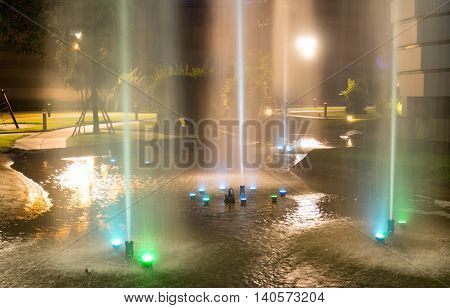 Fountains at night. Light blue and green.