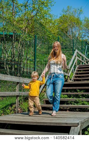 Mother And Son On A Wooden Ladder
