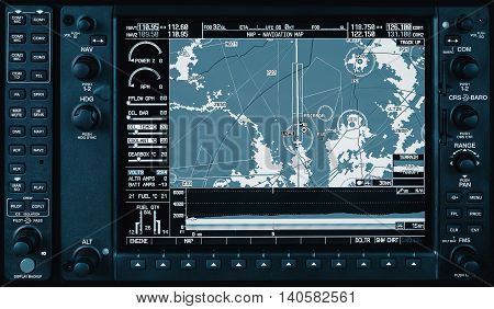 Airplane glass cockpit display G1000 with weather radar and engine gauges in small private airplane