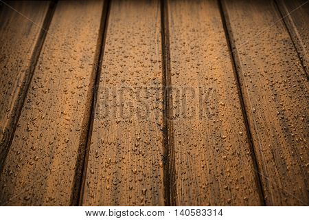 dark brown wood panels after rain with drops