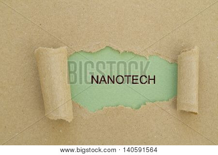 Nanotech word written under torn paper .