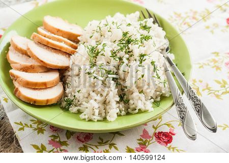 White Rice With Greens And Sliced Pieces Of Meat Grilled On A Green Plate