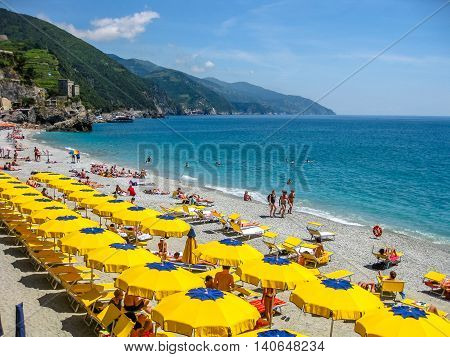 Monterosso al Mare, Ligurian Coast, Italy - June 4, 2010: colorful beach umbrella at the Monterosso beach in Cinque Terre National Park.