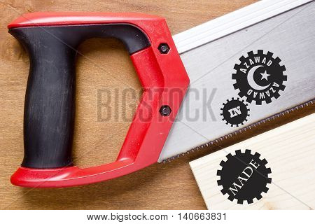 Industrial poster Made in Azawad the stamp imprint on a tree and hacksaw.