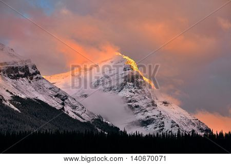 Snow capped mountain and fog at sunset in Yoho National Park in Canada