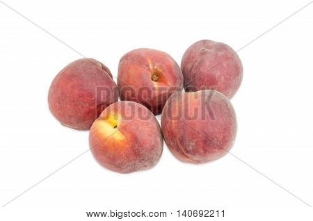 Several ripe fresh peaches on a light background