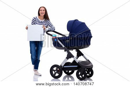 Full length portrait of a mother with a stroller holding blank card, isolated on white background