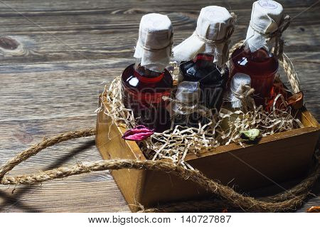 Small bottles of liquor in a wooden box on a wooden background. Small bottle with alcohol.