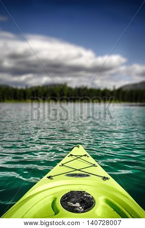 Neon green kayak on the water at Horseshoe Lake, Montana