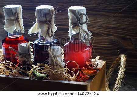 Small bottles of liquor in a wooden box on a wooden background. Small bottle with alcohol.